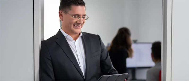 Man in suit checking his tablet