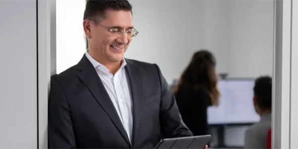 Man in suit checking his tablet