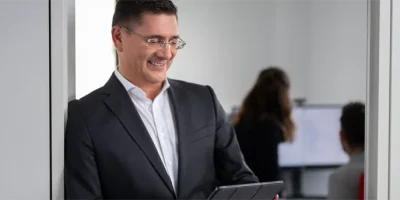 Man in suit checking his tablet